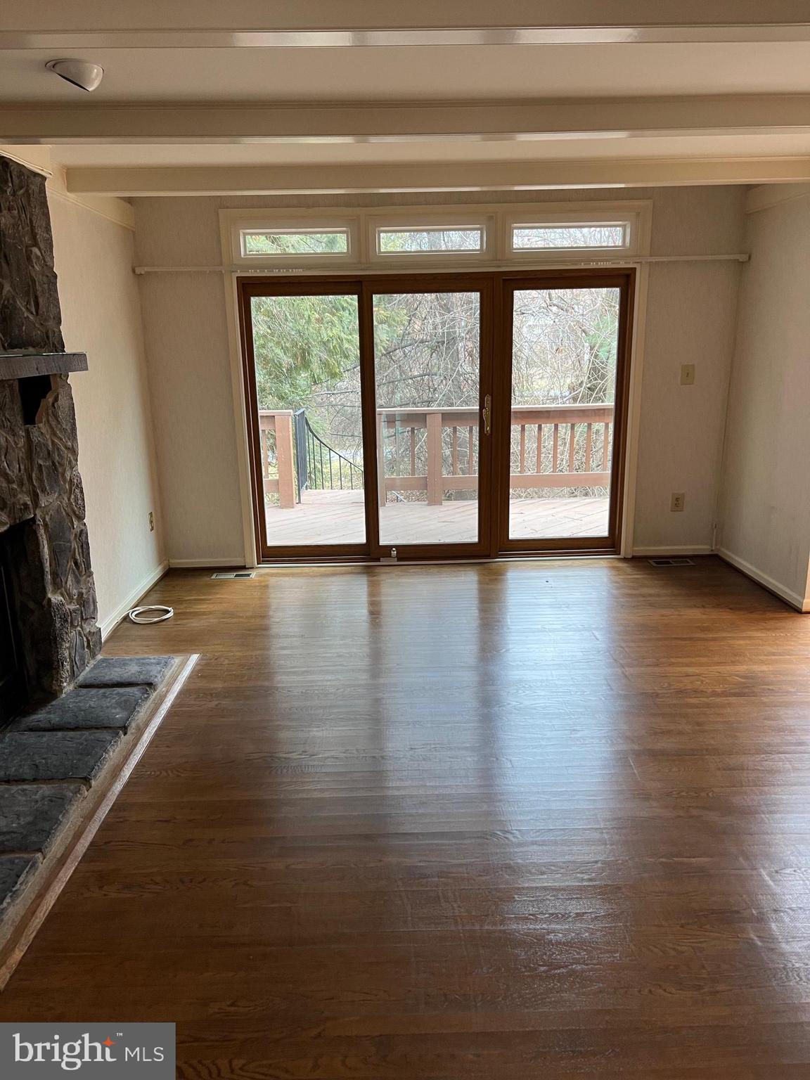 10775 Brewer House Road Rockville, MD 20852 - Photo 3 of 19 a view of an empty room with wooden floor and a window