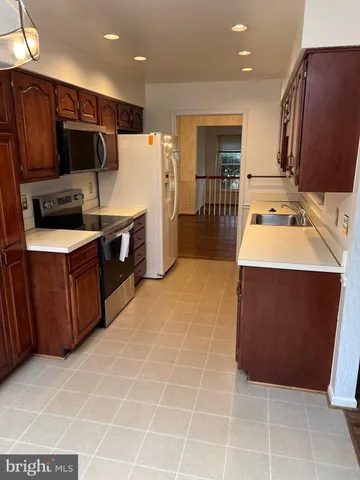 a kitchen with stainless steel appliances a sink and a counter top space
