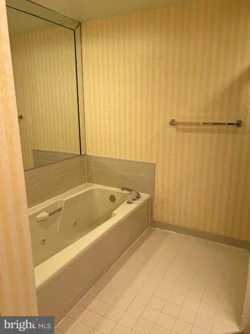 a white toilet sitting next to a shower curtain