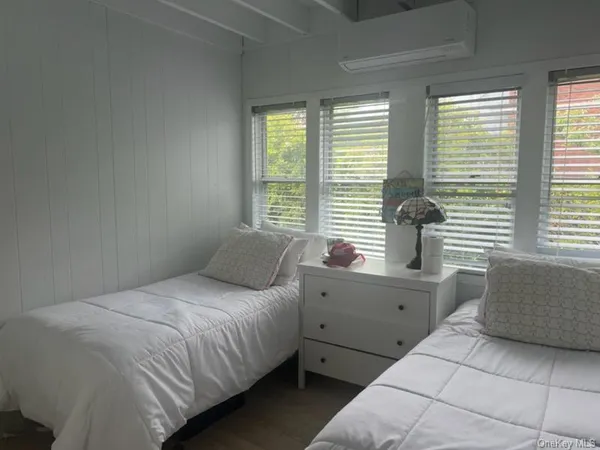 a bedroom with a large bed and windows