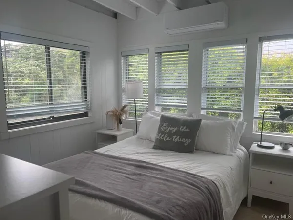 a bedroom with a large bed and a window