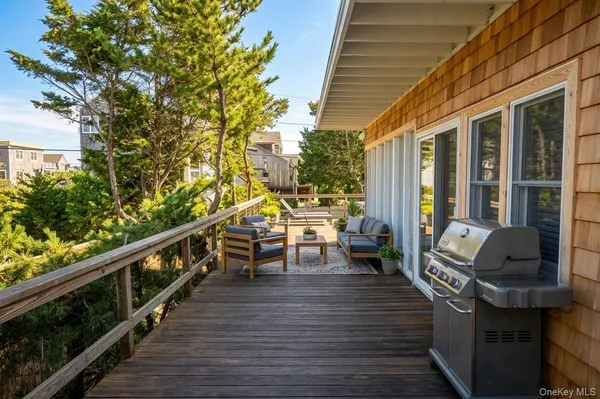 a view of balcony with chairs and wooden fence