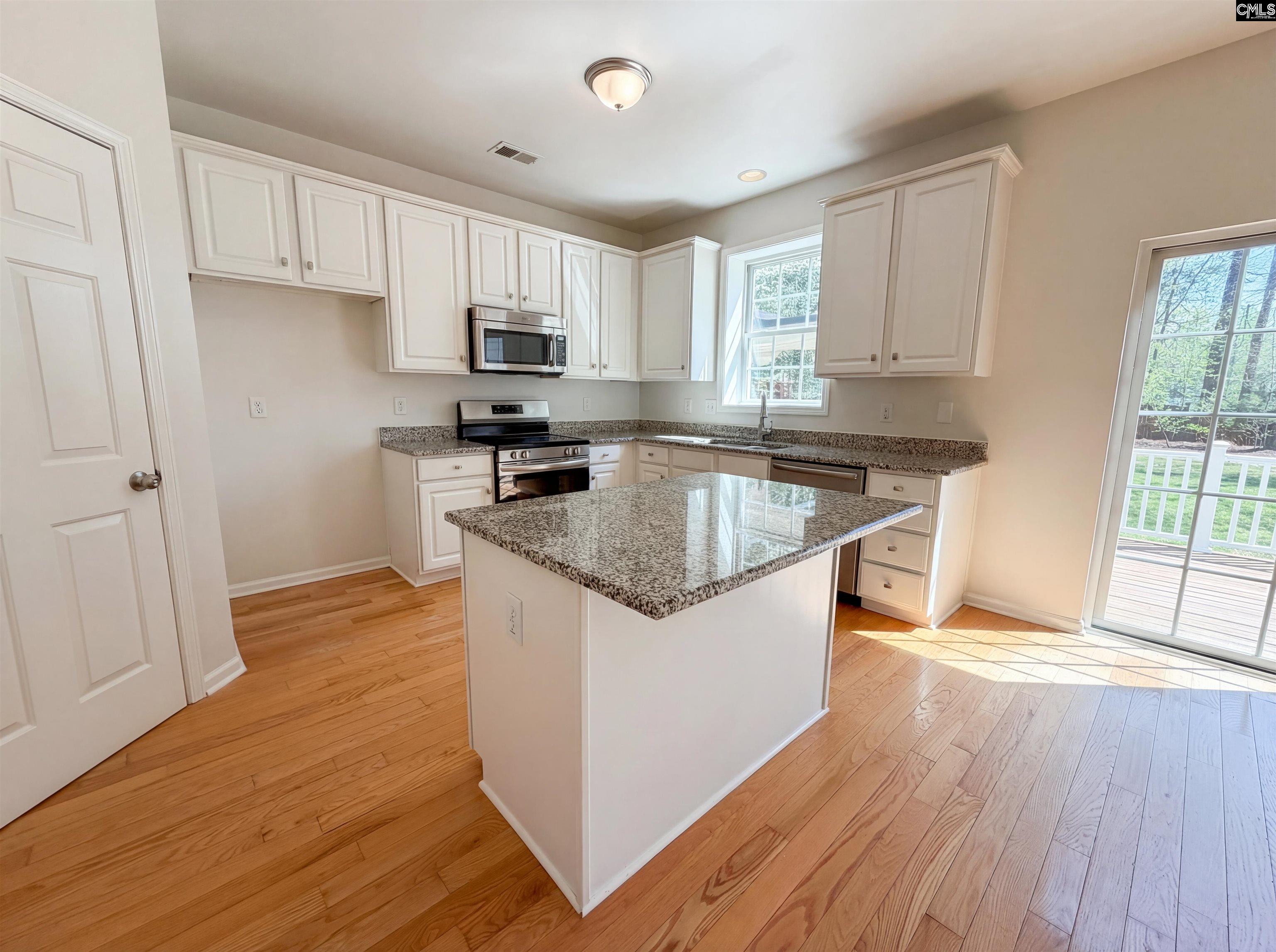 112 Coopers Hawk Circle Irmo, SC 29063 - Photo 2 of 26 a kitchen with stainless steel appliances granite countertop a stove a sink dishwasher and a refrigerator with wooden floor