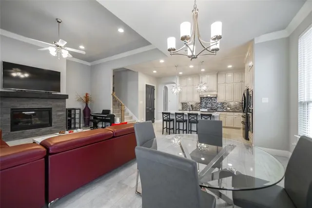 a view of a dining room with furniture a fireplace and chandelier