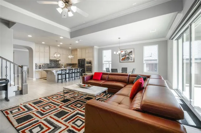 a living room with furniture and kitchen view