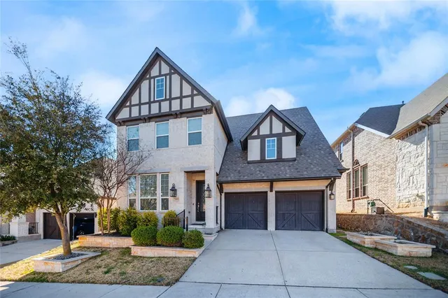 a front view of a house with yard and tress