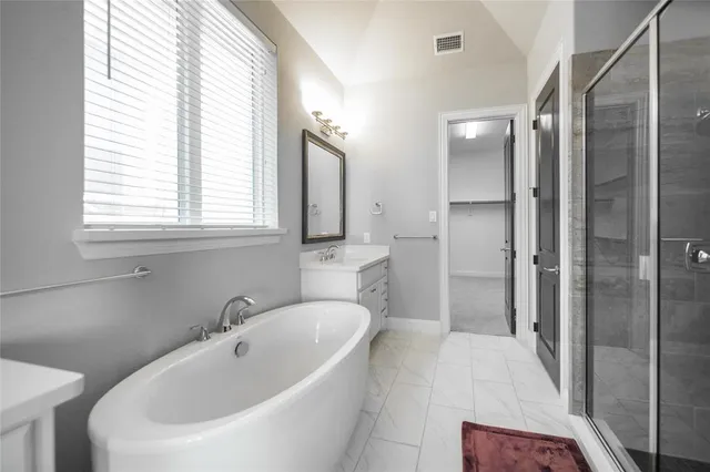 a bathroom with a bathtub and a sink