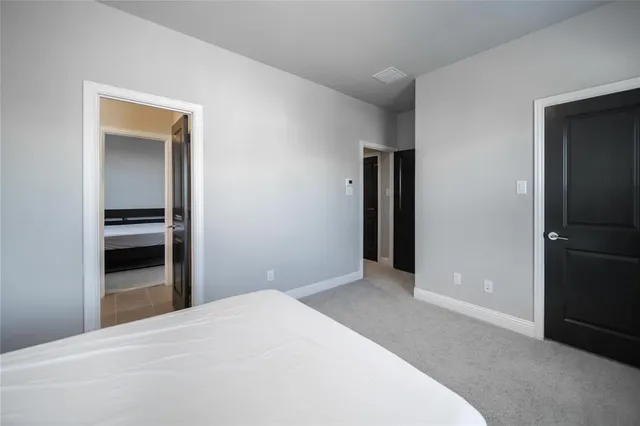 a bedroom with a bed and a television