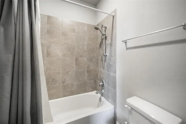 a bathroom with a shower and a toilet