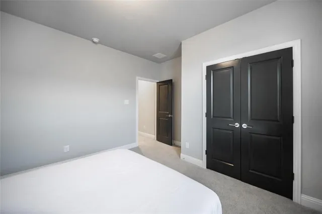 a bedroom with a bed and a bathroom