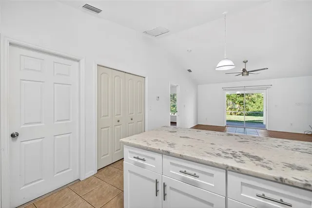 a bathroom with a granite countertop sink and window