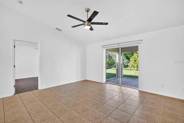 a view of a livingroom with a ceiling fan and window