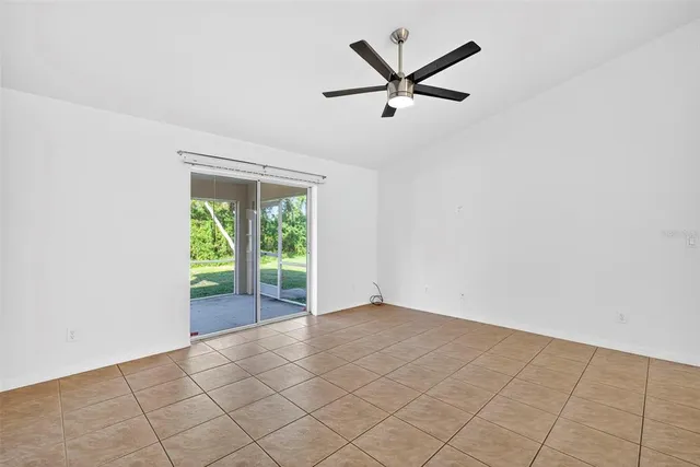 a view of a big room with wooden floor and windows