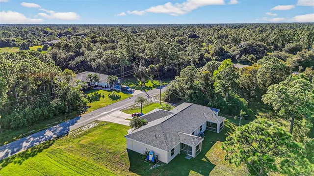 an aerial view of a house with a swimming pool yard and outdoor seating