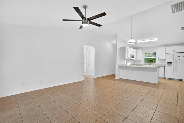a view of kitchen with granite countertop cabinets and white appliances