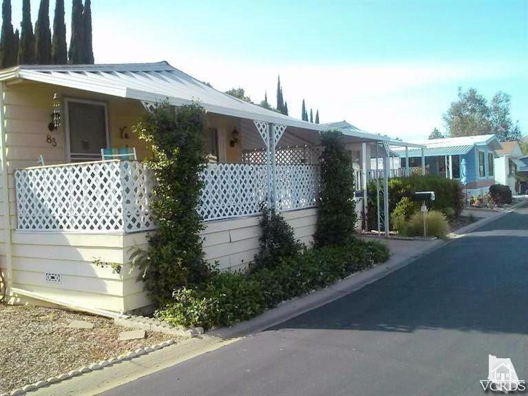6480 Katherine Road, Unit 83 Simi Valley, CA 93063 - Photo 4 of 9 a front view of a house with garden
