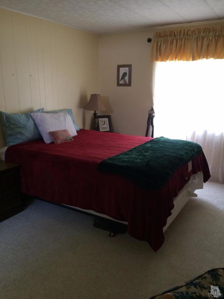 6480 Katherine Road, Unit 83 Simi Valley, CA 93063 - Photo 8 of 9 a bedroom with a bed and a window