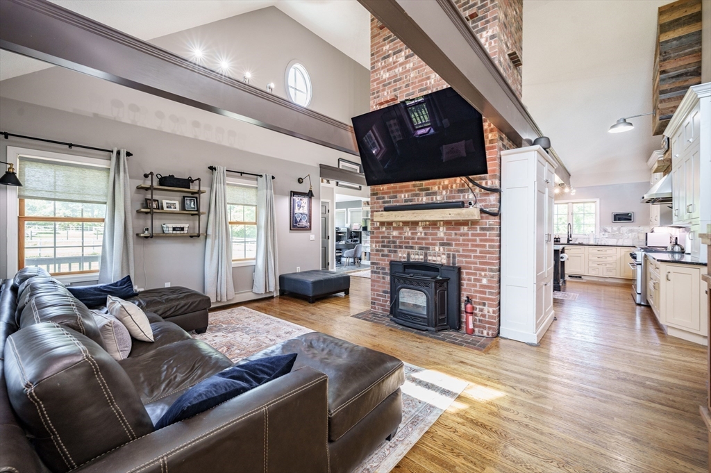 29 Bolles Road Wilbraham, MA 01095 - Photo 5 of 36 a living room with furniture flat screen tv and a fireplace