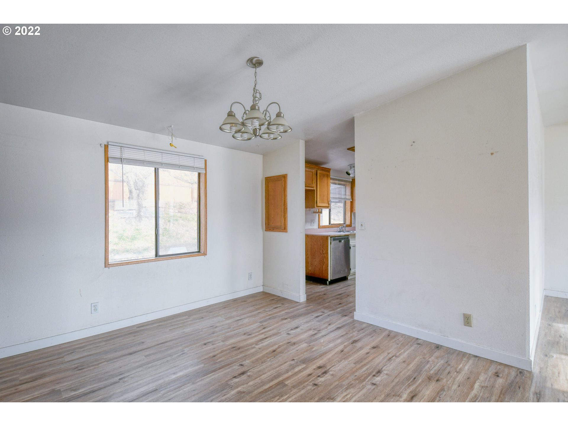 809 Southwest 11th Street Pendleton, OR 97801 - Photo 13 of 32 a view of an empty room with a window and wooden floor