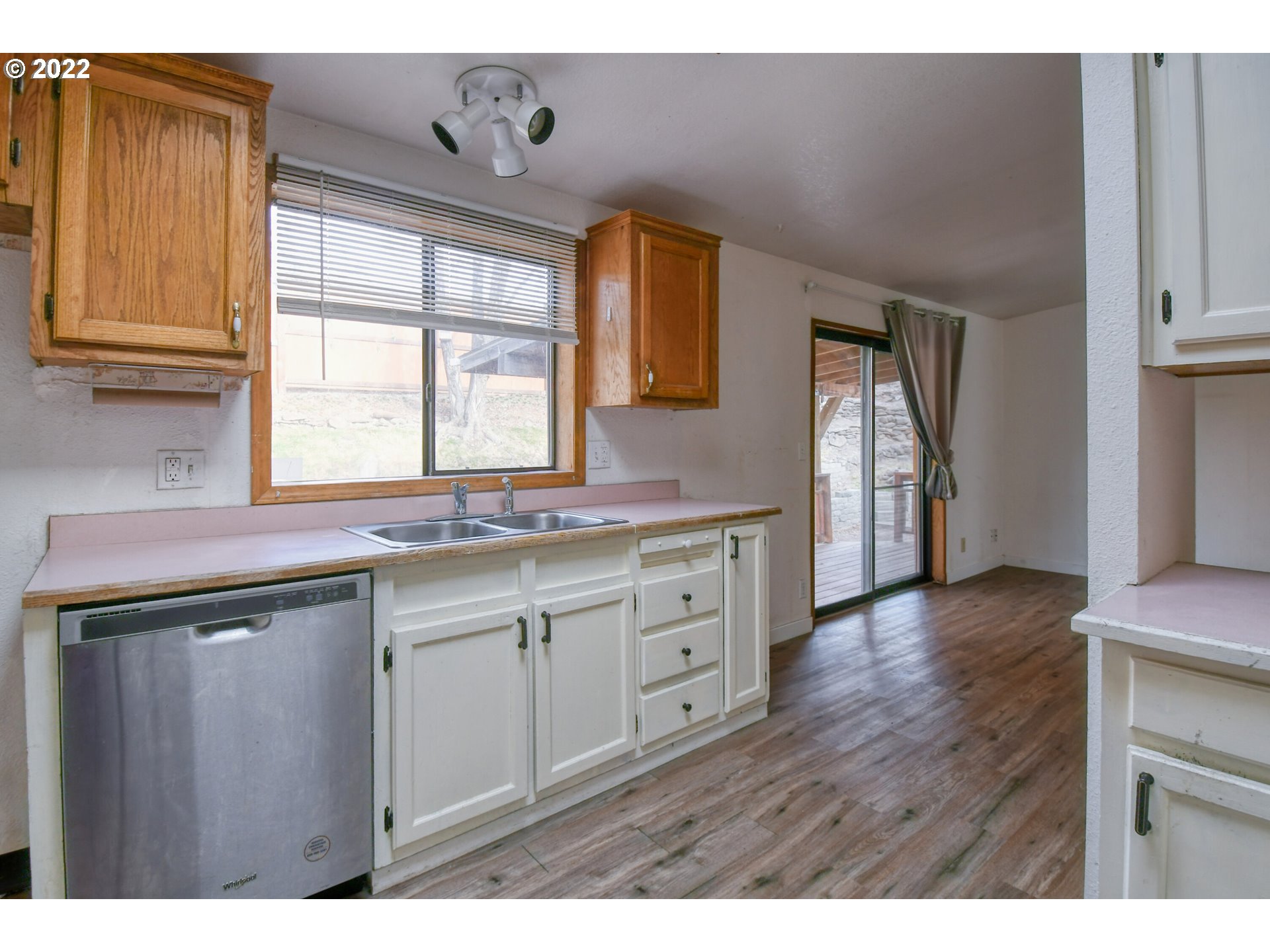 809 Southwest 11th Street Pendleton, OR 97801 - Photo 16 of 32 a kitchen with granite countertop a sink cabinets and wooden floor