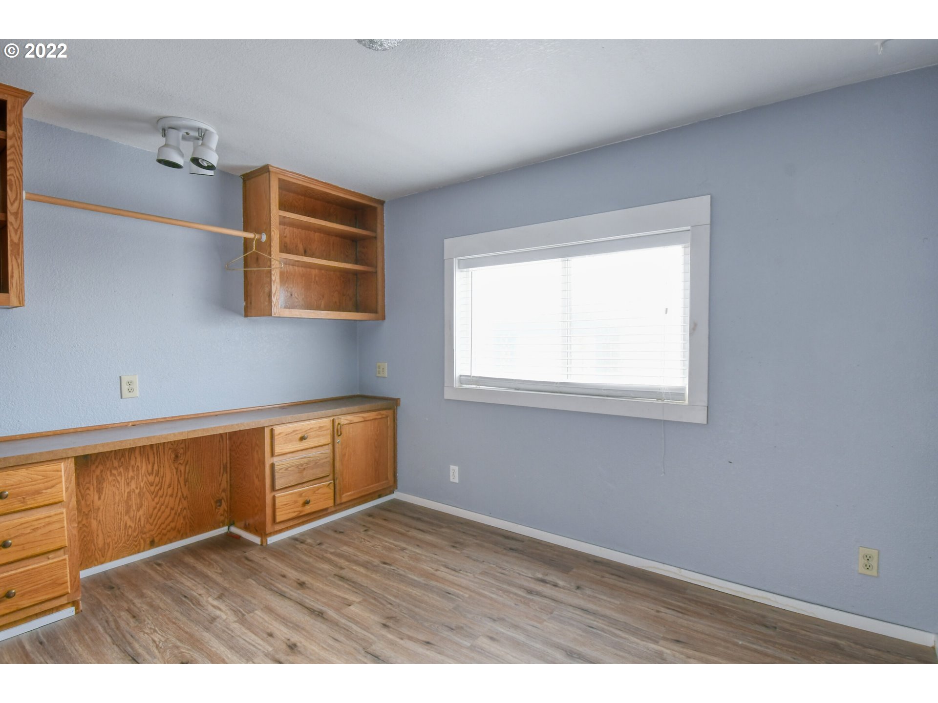 809 Southwest 11th Street Pendleton, OR 97801 - Photo 23 of 32 a view of an empty room with wooden floor and a window
