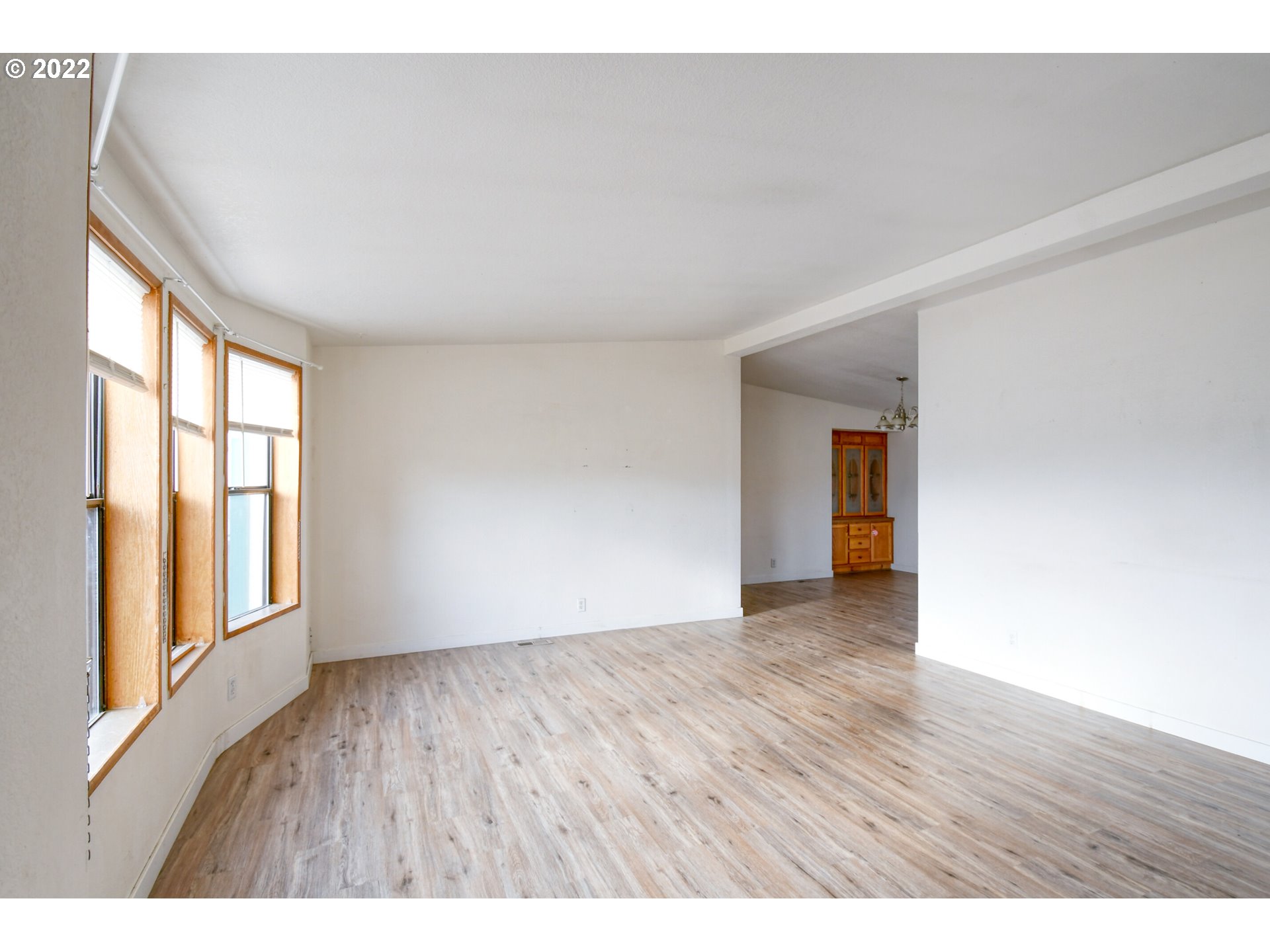 809 Southwest 11th Street Pendleton, OR 97801 - Photo 8 of 32 a view of an empty room with wooden floor and a window