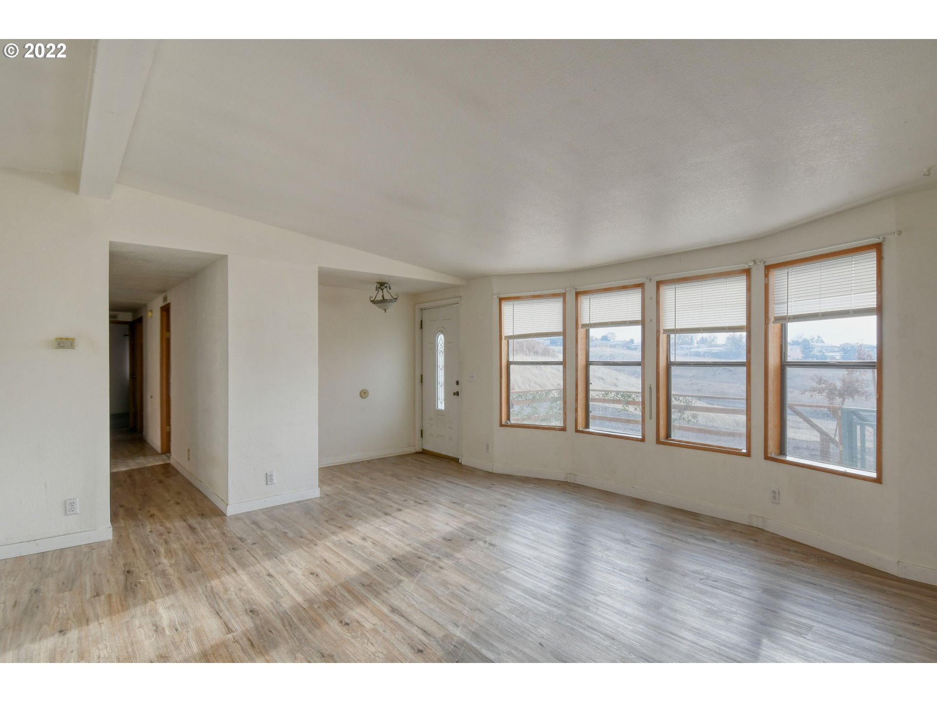809 Southwest 11th Street Pendleton, OR 97801 - Photo 10 of 32 a view of an empty room with a window and wooden floor