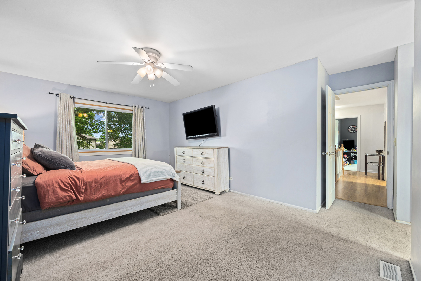 302 Thistle Drive Bolingbrook, IL 60490 - Photo 15 of 33 a spacious bedroom with a bed and a flat screen tv