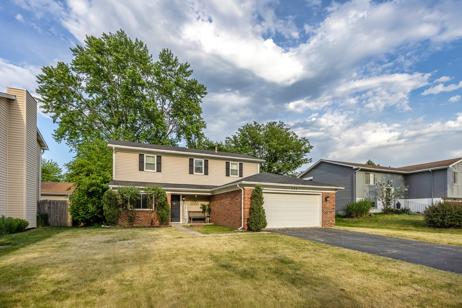 302 Thistle Drive Bolingbrook, IL 60490 - Photo 2 of 33 a front view of a house with a yard and garage