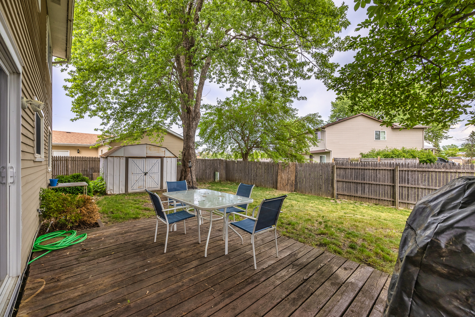 302 Thistle Drive Bolingbrook, IL 60490 - Photo 28 of 33 a view of a chair and table on the wooden deck