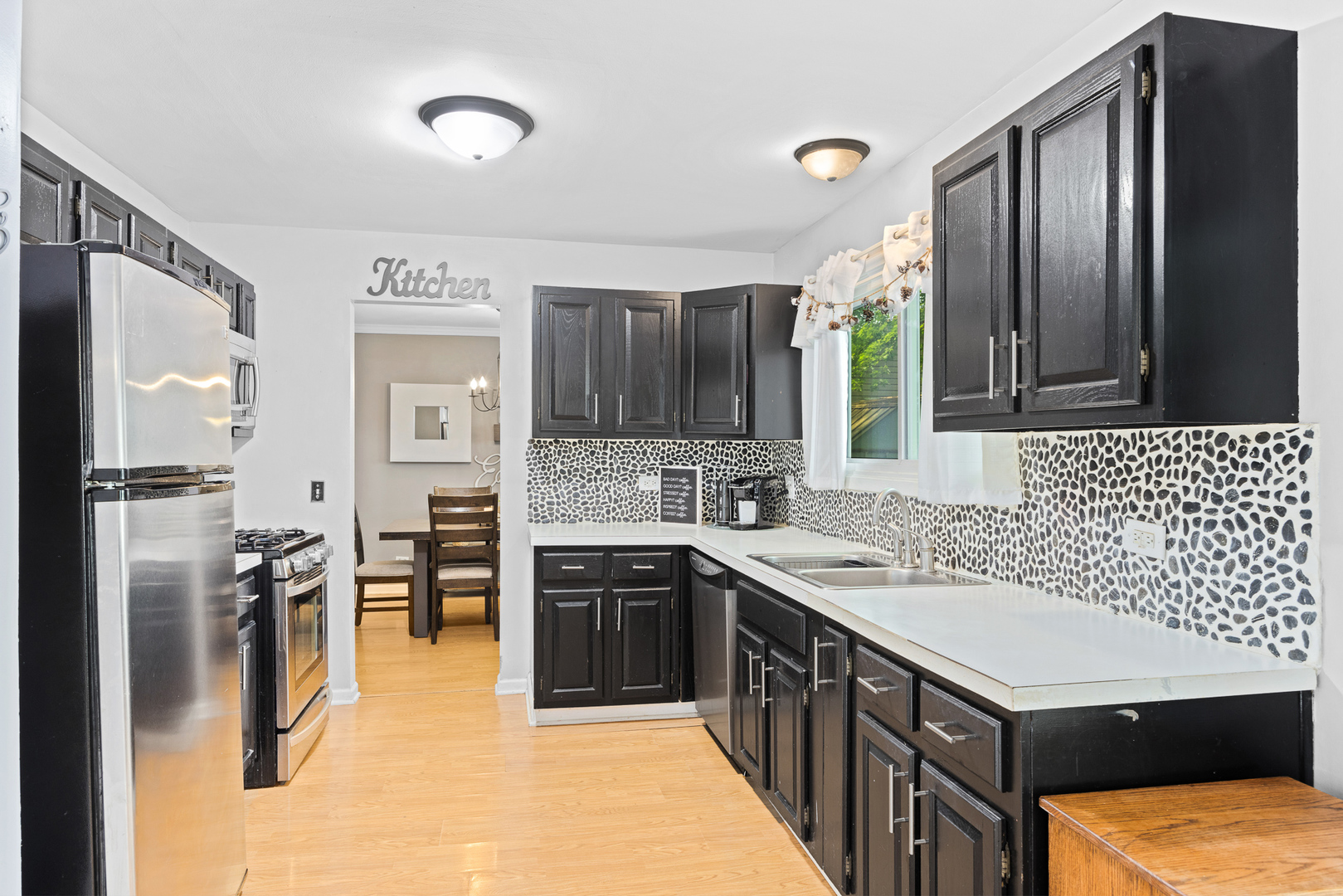 302 Thistle Drive Bolingbrook, IL 60490 - Photo 7 of 33 a kitchen with a sink refrigerator and cabinets