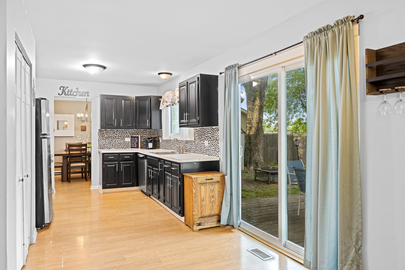 302 Thistle Drive Bolingbrook, IL 60490 - Photo 8 of 33 a large kitchen with a large window and stainless steel appliances