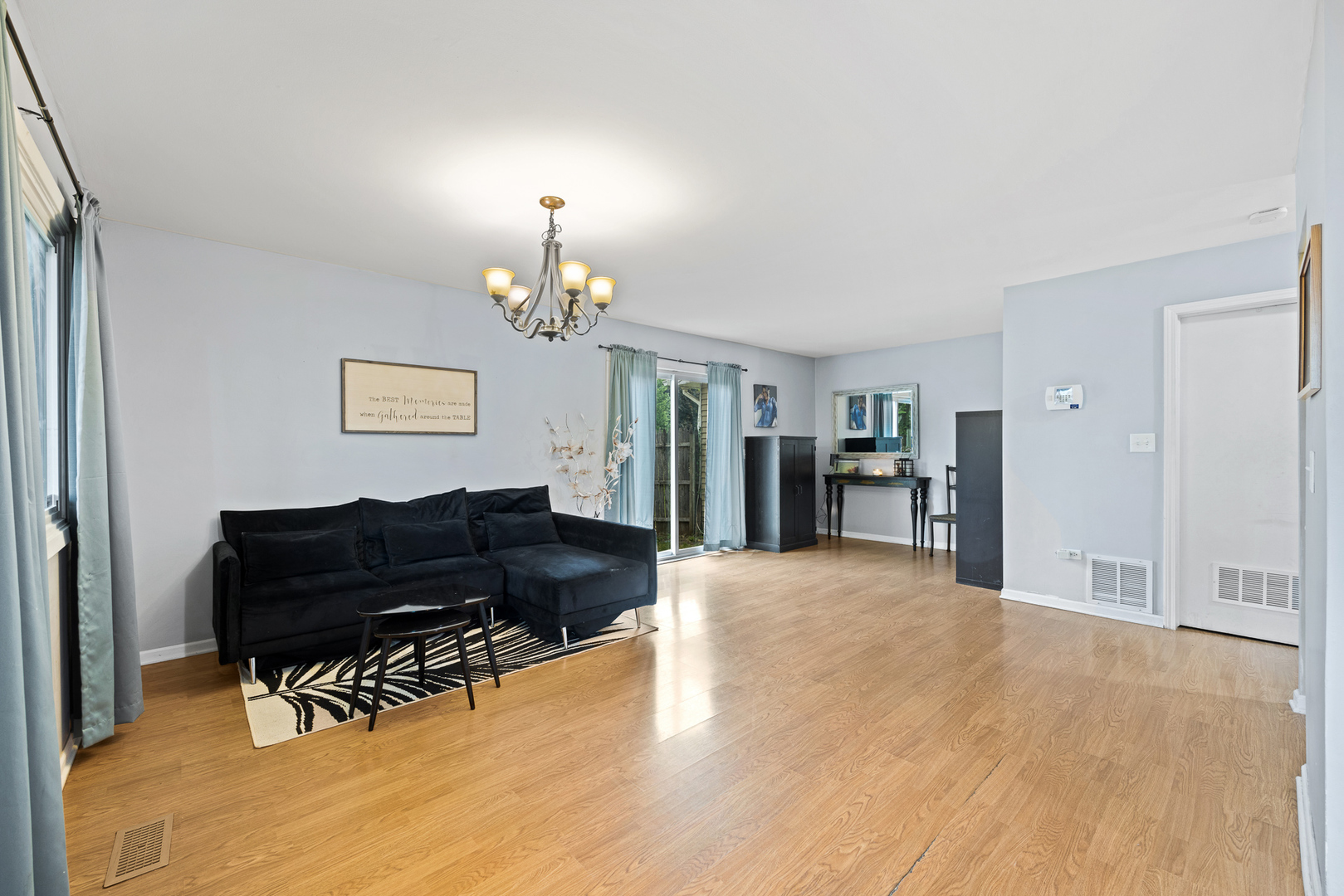 302 Thistle Drive Bolingbrook, IL 60490 - Photo 9 of 33 a living room with furniture and a chandelier