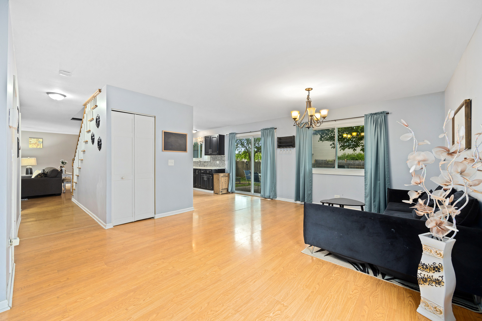 302 Thistle Drive Bolingbrook, IL 60490 - Photo 10 of 33 a view of a livingroom with furniture a chandelier and wooden floor