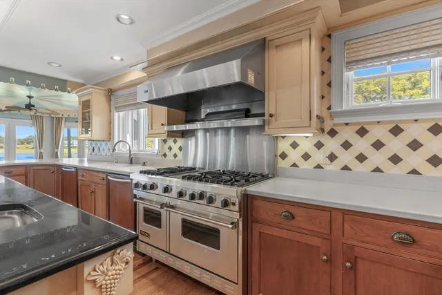 a kitchen with granite countertop a stove and a sink