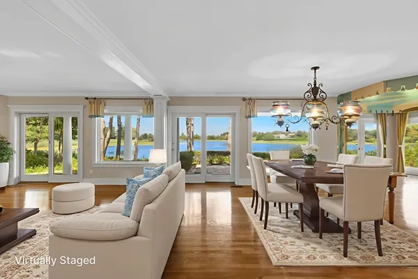 a living room with fireplace furniture and a large window