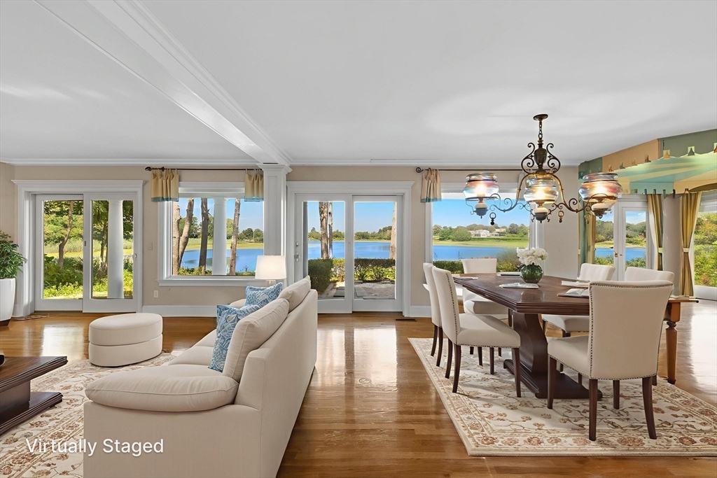 4390 Main Street Barnstable, MA 02675 - Photo 14 of 42 a living room with fireplace furniture and a large window