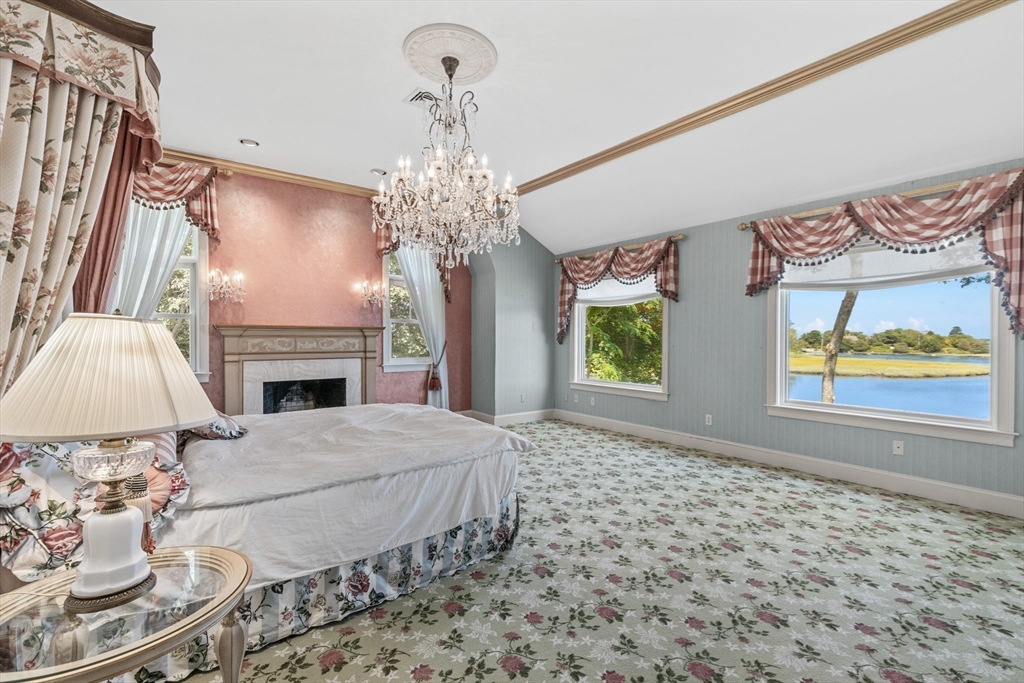 4390 Main Street Barnstable, MA 02675 - Photo 17 of 42 a bedroom with a bed and a fireplace