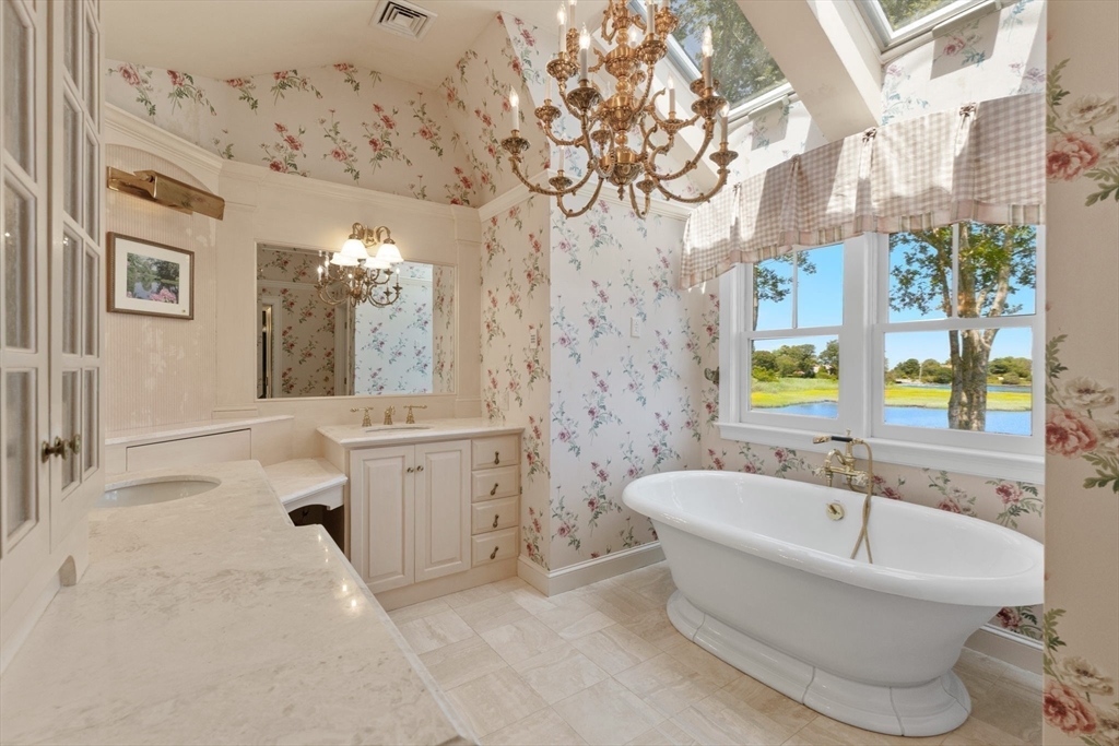 4390 Main Street Barnstable, MA 02675 - Photo 20 of 42 a spacious bathroom with a bathtub and a sink