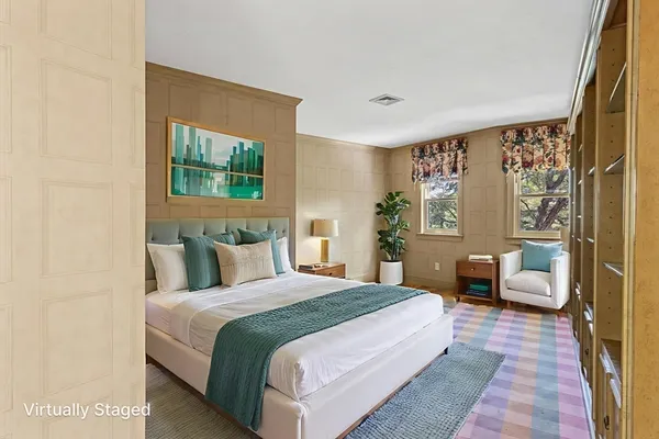 a bedroom with a large bed couch and a window