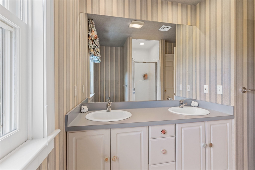 4390 Main Street Barnstable, MA 02675 - Photo 33 of 42 a bathroom with a sink and a mirror