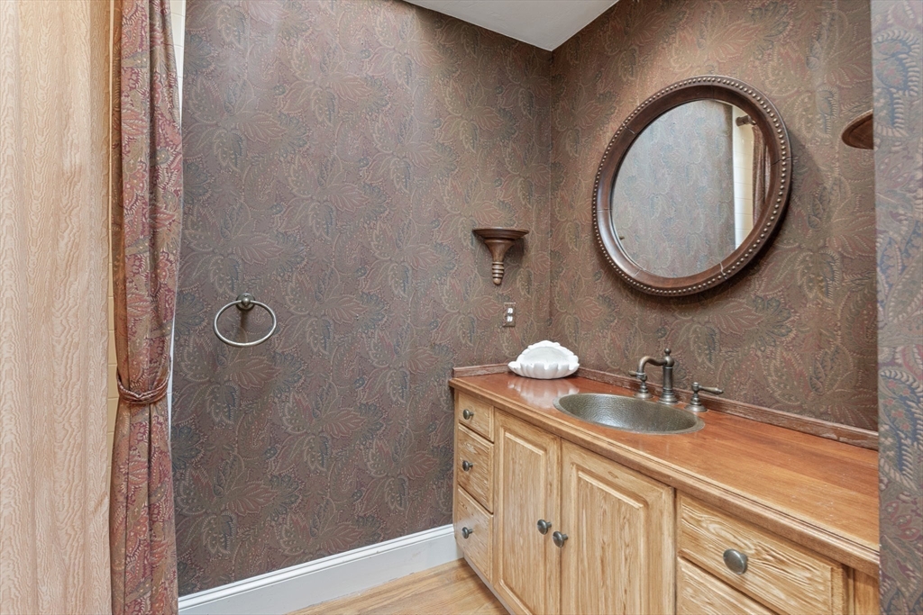 4390 Main Street Barnstable, MA 02675 - Photo 34 of 42 a bathroom with a sink a mirror and a light fixture