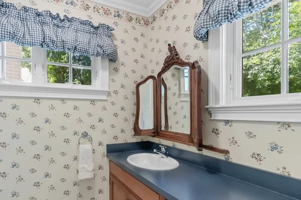a bathroom with a sink a mirror and a window