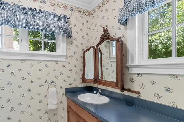a bathroom with a sink a mirror and a window