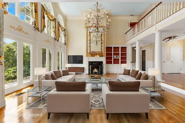 a living room with fireplace furniture and a large window