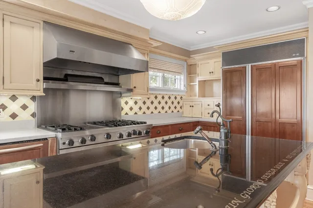 a kitchen with granite countertop a stove and a refrigerator