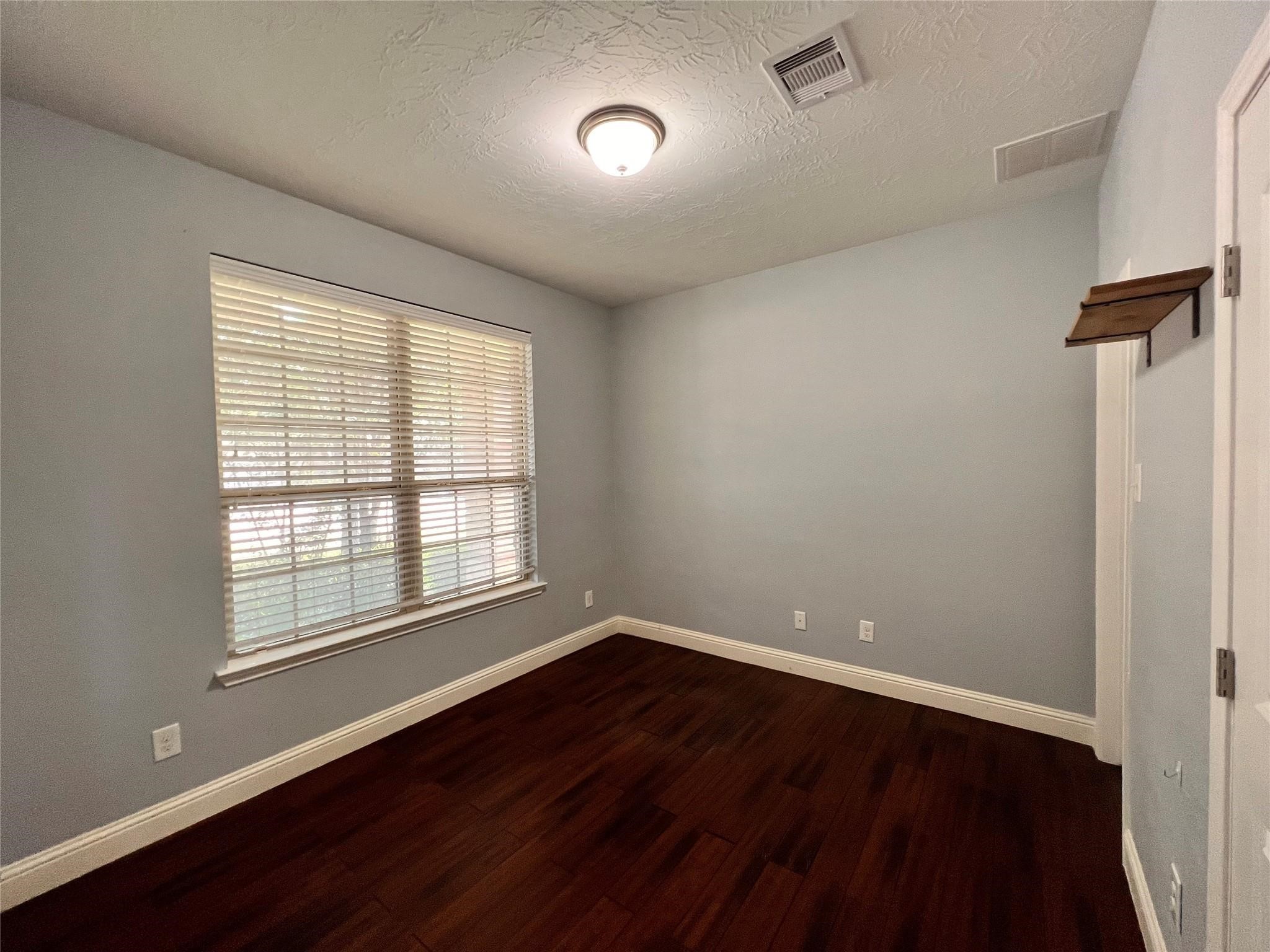 26842 Trinity Trail Cypress, TX 77433 - Photo 16 of 31 a view of an empty room with wooden floor and a window