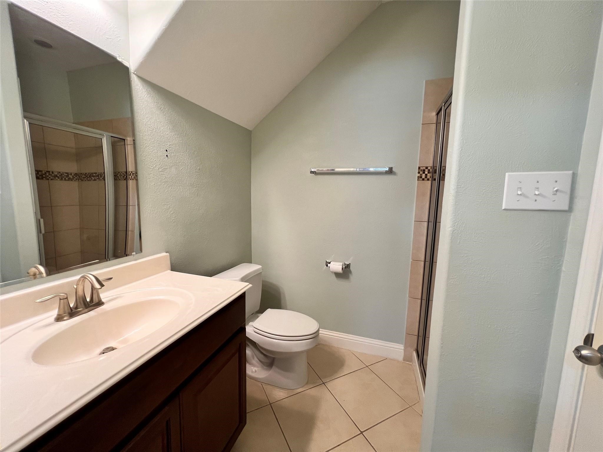 26842 Trinity Trail Cypress, TX 77433 - Photo 17 of 31 a bathroom with a sink a toilet a shower and a mirror