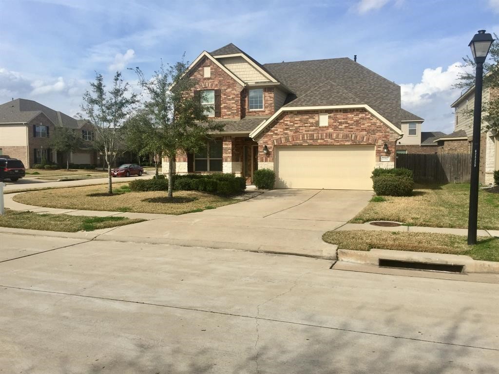 26842 Trinity Trail Cypress, TX 77433 - Photo 2 of 31 a front view of a house with a yard