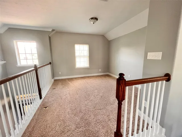 a view of a hallway with windows